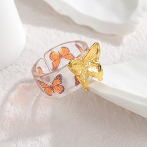 Elegant 3D golden butterfly ring with orange print in clear resin, open adjustable band