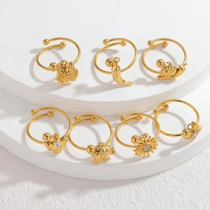 7-piece set of 18k gold plated stainless steel open rings with animal charms on white stand