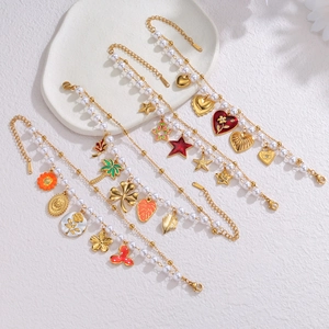 Detailed shot of 18k gold plated bracelets with colorful charms and white pearls