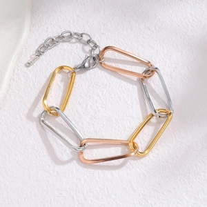 Three-tone stainless steel geometric link bracelet with gold, silver, and rose gold rings