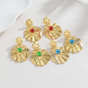 Detail of 18k gold vintage disc earrings featuring tiger eye stones in red green and blue