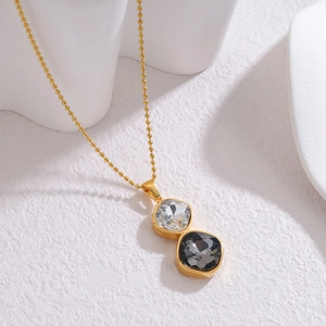18k gold plated geometric necklace with stacked white and grey square crystal pendants