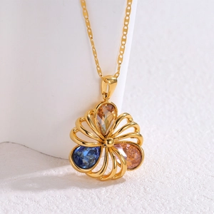 18k gold hollow flower pendant necklace with teardrop zircon gems on white surface