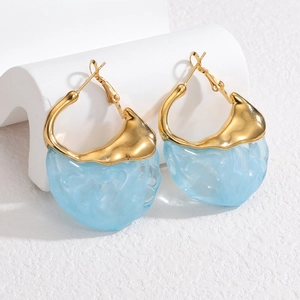 Vintage irregular golden lava and blue resin earrings displayed on a white stand