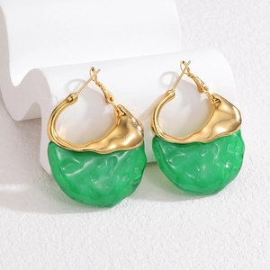 Retro gold hoop earrings with bright green irregular resin charms on white props