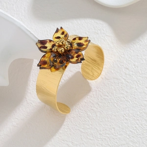 Gold open cuff bracelet with leopard print resin flower and vintage brushed metal finish