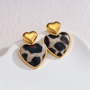 18k gold heart earrings with leopard print pattern on white minimalist stand