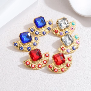 Detail of retro bohemian fan-shaped earrings with 18k gold plating and evil eye charms