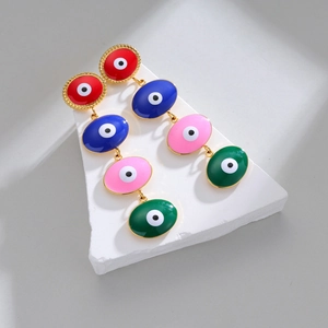 Boucles d'oreilles bohèmes Evil Eye avec modules en émail coloré et détails dorés