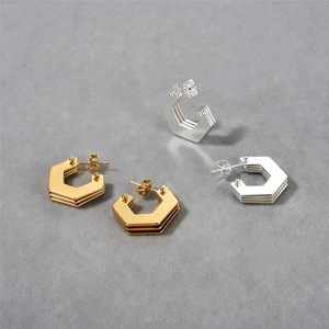 Close-up of geometric hexagon layered hoop earrings with high-polished gold finish