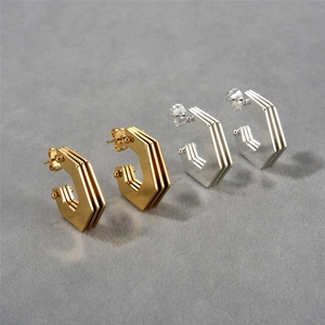Modern geometric C-shaped hoop earrings with layered textures in gold and silver finish