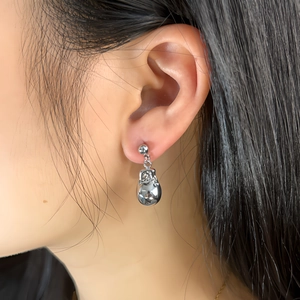 Silver liquid teardrop earrings with geometric mirror finish on female model