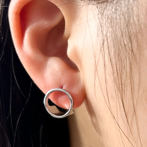 Polished silver geometric hoop earring shown worn on model for a minimalist fashion look