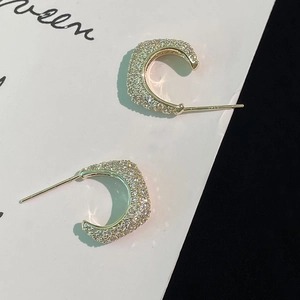 Detailed view of s925 silver moon earrings with 18k gold plating and paved zircon stones