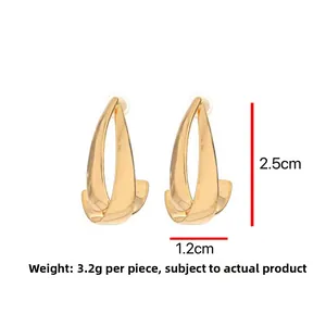 Detail view of twisted gold drop earrings showing dimensions 2.5cm by 1.2cm and 3.2g weight