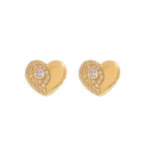 Elegant gold heart earrings with white cubic zirconia pavé on minimalist white background