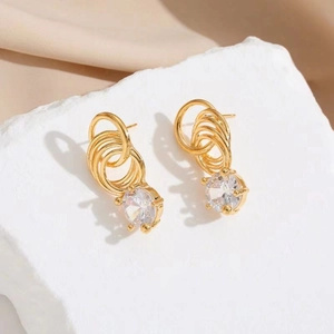 Fashion 18K gold layered hoop earrings with sparkling cubic zirconia drops on marble
