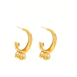 Minimalist C-shaped gold hoop earrings with small metal beads for a trendy female look