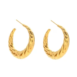 Minimalist golden hollow C-shaped hoop earrings with twisted texture in symmetrical layout