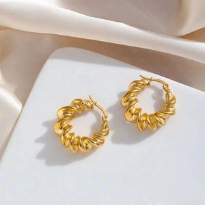 Classic gold twisted C-shape hoop earrings for women with elegant satin background