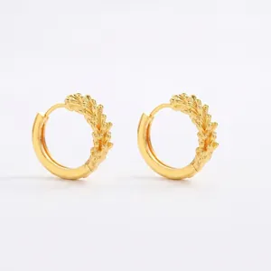 Golden hoop earrings featuring a blend of smooth polish and textured wheat ear patterns