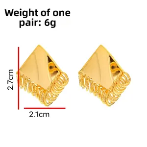 Detail view of geometric diamond gold earrings showing textured spiral metal rings