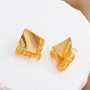 Minimalist geometric rhombic gold earrings with dangling metal rings on stone display