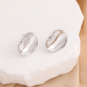 Irregular silver petal stud earrings on stone background for a minimalist luxury look