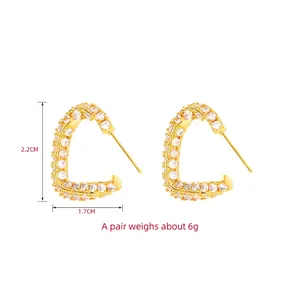 Gold triangle stud earrings with full white crystal pavé setting, size 2.2x1.7cm