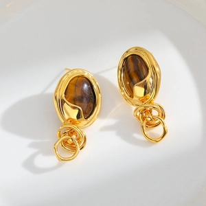 Golden drop earrings featuring tiger eye stone and elegant interlocking metal rings