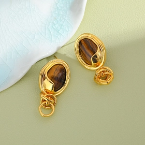 Vintage gold earrings featuring tiger eye stones and interlocking metal rings design
