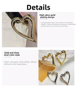 Detail view of large heart-shaped hoop earrings in polished gold and silver finishes