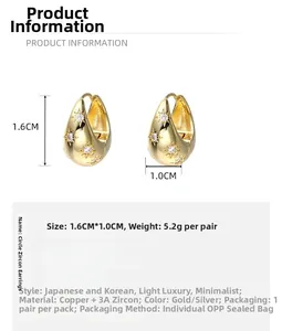 Detail view of gold-plated oval earrings with cubic zirconia and 1.6cm size specs