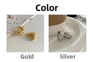 Detail of gold and silver hoop earrings with engraved star patterns and cubic zirconia