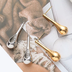 Minimalist exaggerated teardrop earrings in polished gold and silver finishes