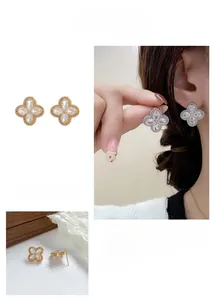 Detailed close-up of 18K gold plated clover earrings with cubic zirconia stones