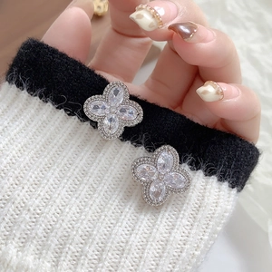 Exquisite silver-tone four-leaf clover earrings with marquise-cut crystals on knit fabric