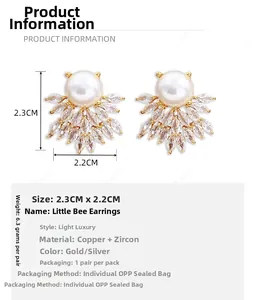 Detail view of pearl and zircon bee earrings showing 2.3cm by 2.2cm size measurements