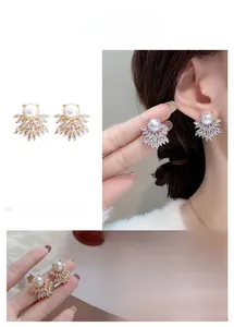 Detail of bee-shaped stud earrings featuring large pearls and marquise-cut crystals
