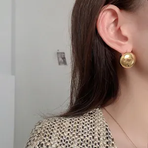 Polished gold spherical geometric stud earrings for women with a high mirror shine finish