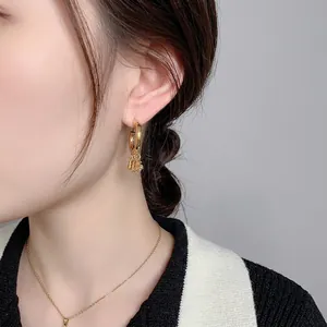 Élégantes créoles plaquées or 18 carats avec glands en zircon sur mannequin