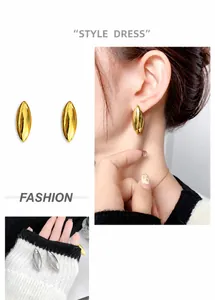 Detailed view of polished canoe geometric stud earrings in gold and silver finishes