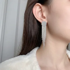 Elegant long silver fringe tassel earrings with polished round studs shown on model