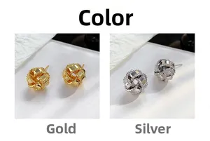 Macro detail of spherical knot stud earrings in polished gold and silver plating