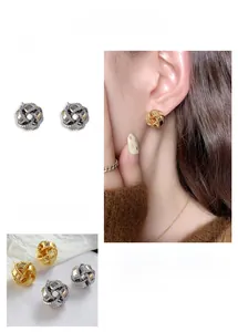 Detail of 18K gold and silver plated spherical woven knot earrings showing metallic texture