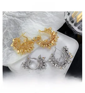Detail shot of vintage style hoop earrings with heart fringe in gold and silver plating