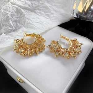 Retro style 18K gold plated hoop earrings with dangling metal heart charms on jewelry box