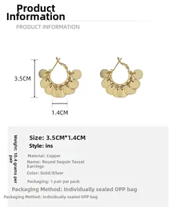 Detail showing gold plated round sequin tassel earrings with 3.5cm length dimensions