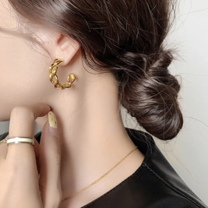 Golden C-shaped chunky chain hoop earrings with industrial metallic twist design