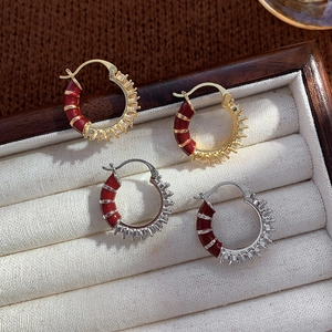 Gold and silver hoop earrings with red enamel and pavé cubic zirconia inlay